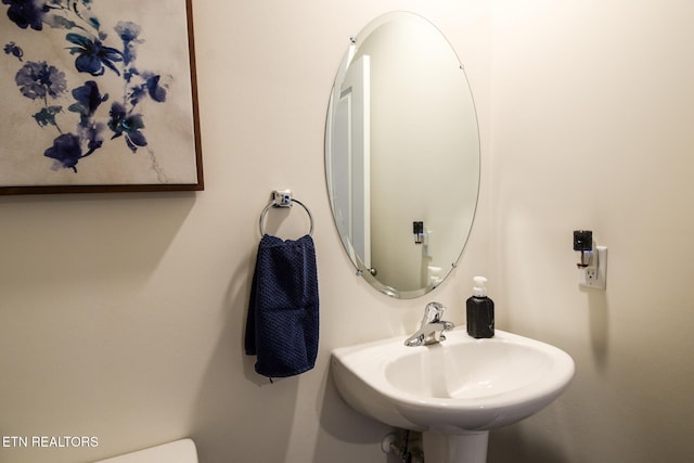 bathroom featuring toilet and a sink