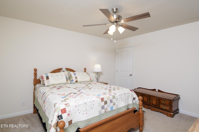 bedroom with baseboards, ceiling fan, and light colored carpet