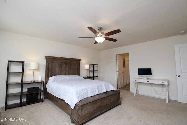 bedroom with light carpet, baseboards, and a ceiling fan