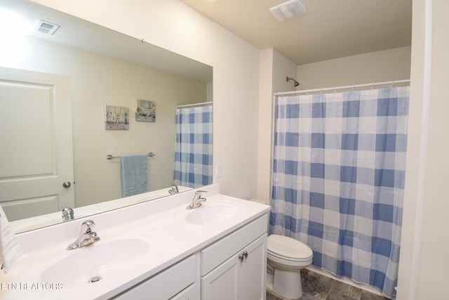 full bathroom featuring toilet, double vanity, a sink, and visible vents