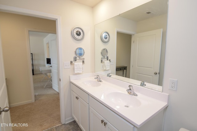 bathroom featuring visible vents, a sink, baseboards, and double vanity