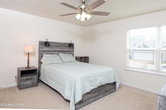 carpeted bedroom featuring ceiling fan and baseboards