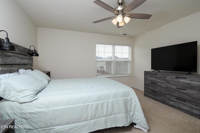 carpeted bedroom with visible vents and ceiling fan