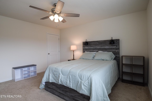 carpeted bedroom with ceiling fan and baseboards