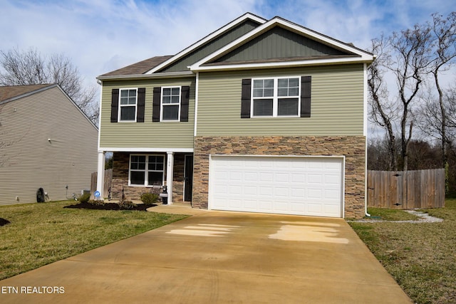 view of front of house featuring an attached garage, driveway, stone siding, and fence