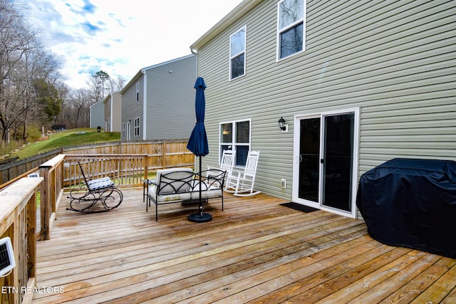 wooden deck featuring fence, outdoor dining area, and area for grilling