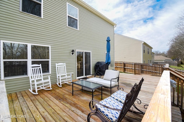 wooden deck featuring a grill