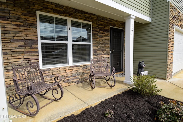 view of patio with a porch and a garage