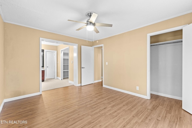 unfurnished bedroom with light wood-style floors, a closet, and crown molding