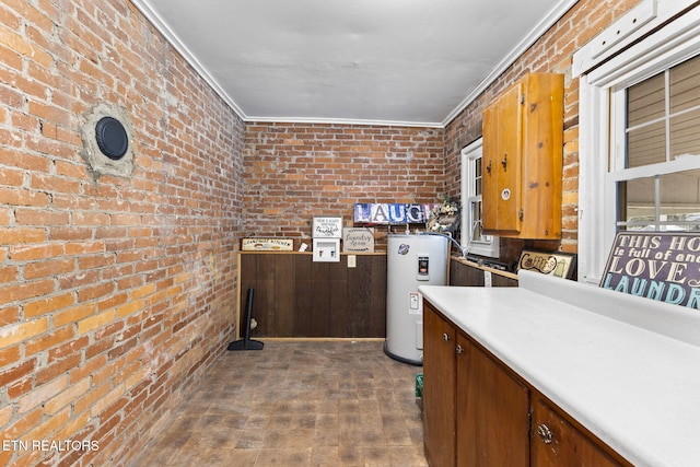 interior space with dark wood-style floors, crown molding, water heater, brown cabinetry, and brick wall