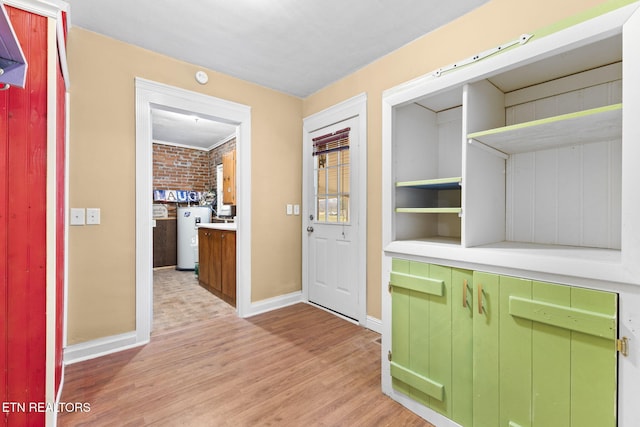 interior space featuring light wood-type flooring, baseboards, and electric water heater