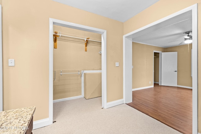 unfurnished bedroom with ceiling fan, baseboards, a closet, and carpet flooring