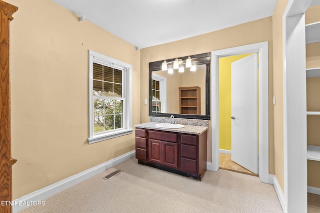 bathroom with visible vents, vanity, and baseboards