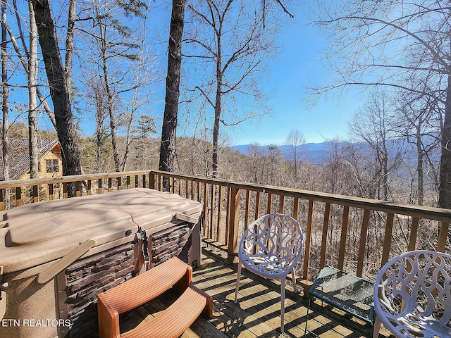 wooden deck featuring a hot tub