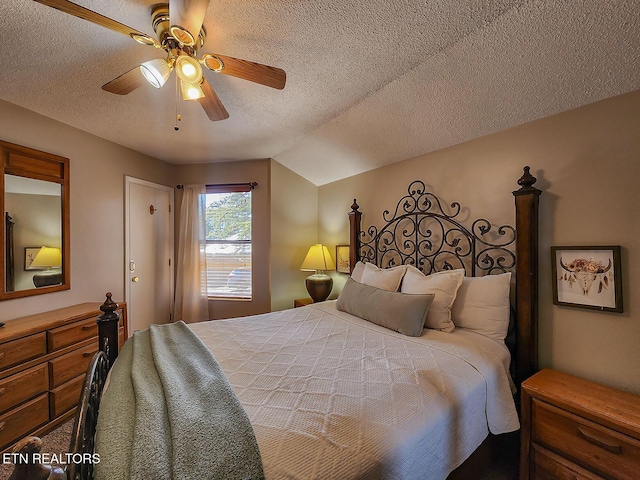 bedroom with a textured ceiling, vaulted ceiling, and a ceiling fan