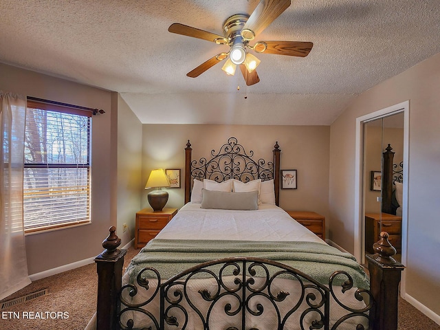 carpeted bedroom featuring visible vents, vaulted ceiling, a textured ceiling, and baseboards