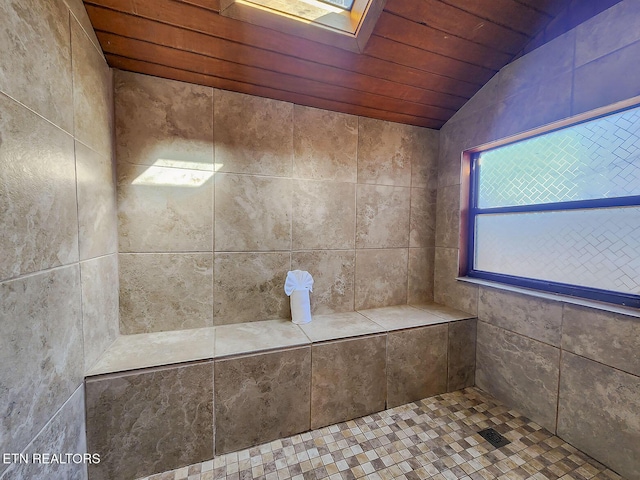 full bath with vaulted ceiling with skylight, tiled shower, and wooden ceiling