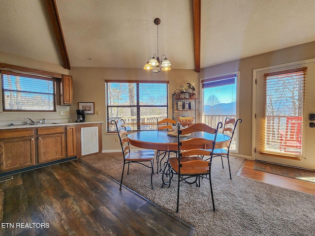 dining space featuring dark wood-style floors, vaulted ceiling with beams, a notable chandelier, and a textured ceiling