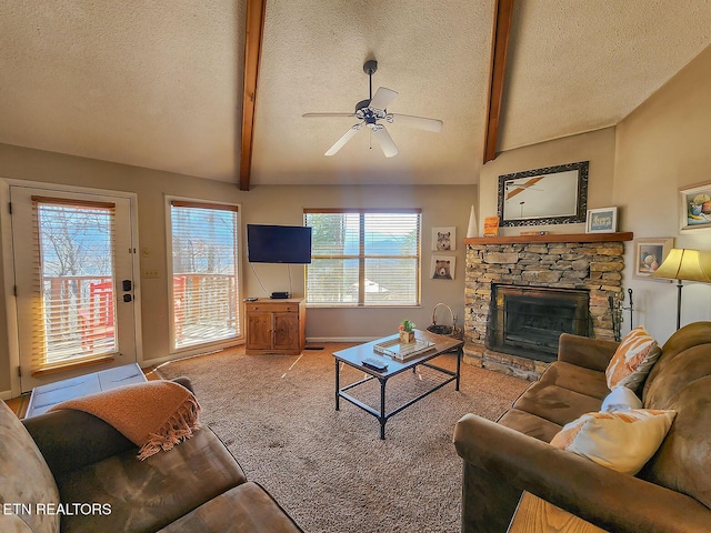 living area featuring carpet, vaulted ceiling with beams, a stone fireplace, and a textured ceiling