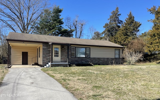 view of front facade featuring a front yard, stone siding, and aphalt driveway