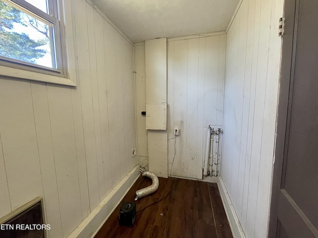 clothes washing area with laundry area and wood finished floors