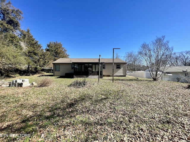 rear view of house featuring fence