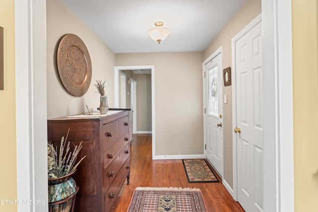 entrance foyer featuring wood finished floors and baseboards