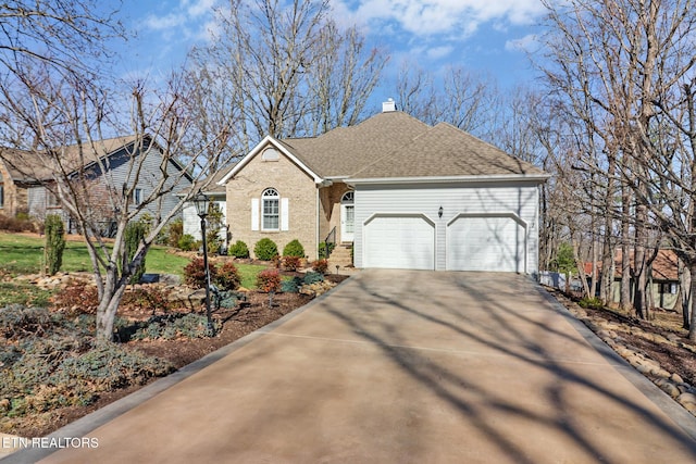 ranch-style home with concrete driveway, a shingled roof, a garage, brick siding, and a chimney