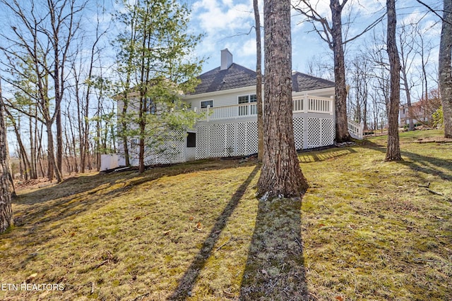 12 Killearn Ct, Crossville, TN 38558 - rear view of property with a yard, a wooden deck, a shingled roof, and a chimney