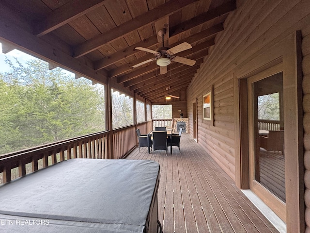 wooden deck with a ceiling fan and outdoor dining space