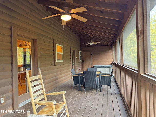 unfurnished sunroom featuring lofted ceiling and ceiling fan