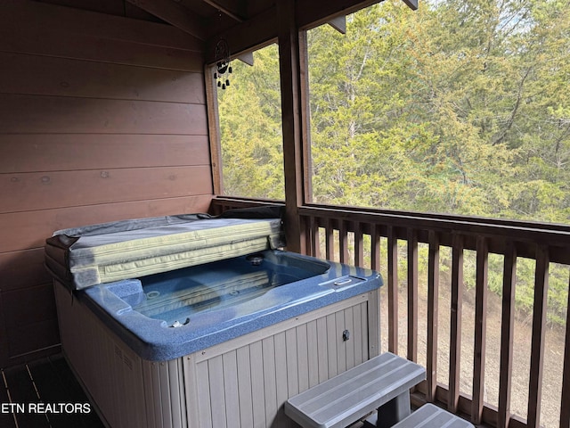 wooden deck featuring a hot tub