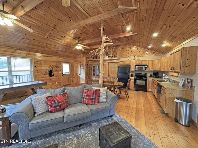 living area with lofted ceiling with beams, light wood-style floors, and ceiling fan