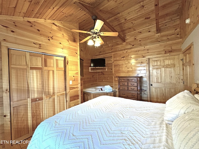 bedroom featuring wooden walls, a ceiling fan, lofted ceiling, wooden ceiling, and a closet