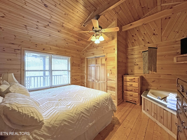 bedroom with light wood finished floors, a ceiling fan, wood walls, wooden ceiling, and beamed ceiling