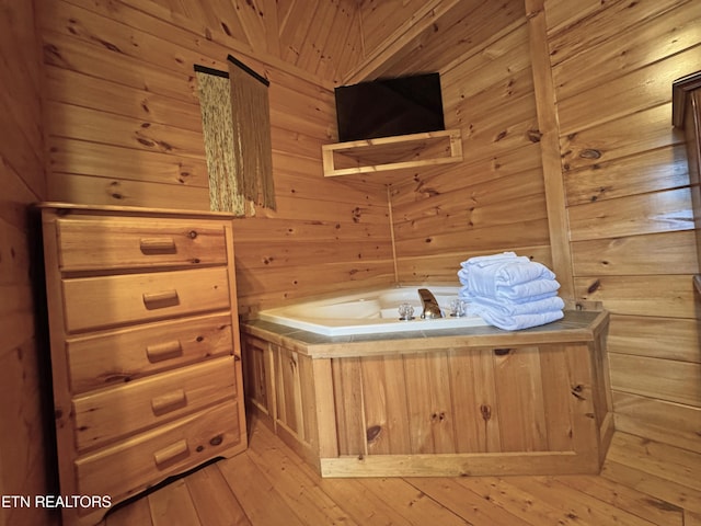 interior space featuring light wood finished floors and wooden walls