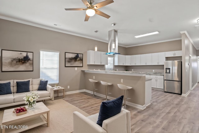 2427 Louise Ave, Knoxville, TN 37915 - living room with ornamental molding, light wood-type flooring, a ceiling fan, and baseboards