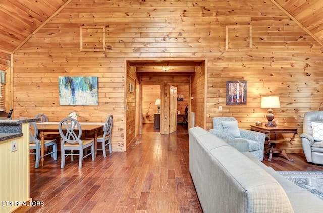 dining room with vaulted ceiling and wood finished floors