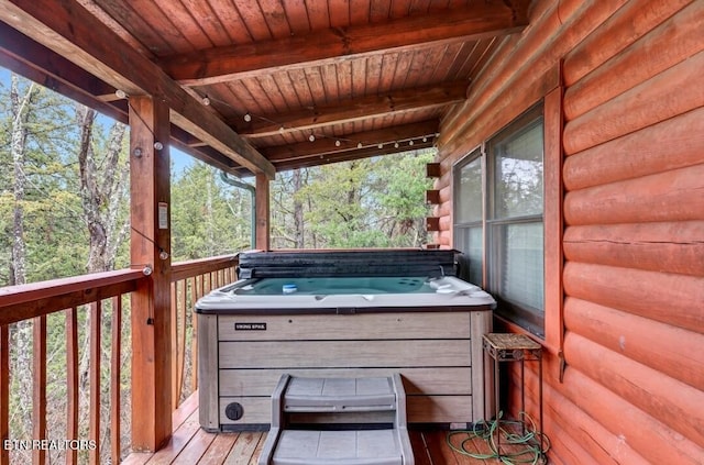 wooden terrace featuring a hot tub