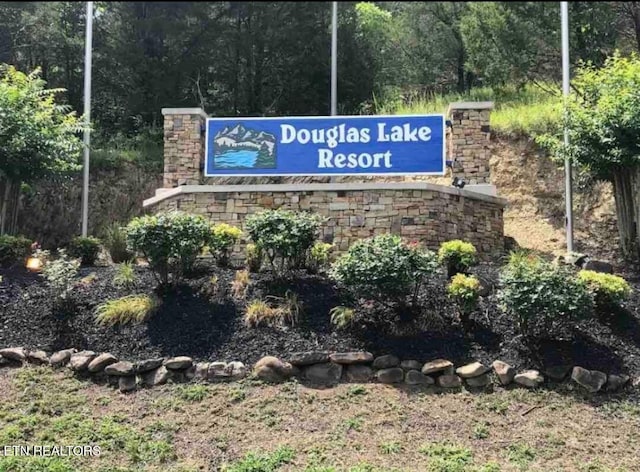 community sign featuring a view of trees