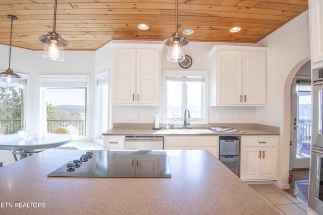 kitchen featuring arched walkways, black electric stovetop, a sink, wood ceiling, and stainless steel dishwasher