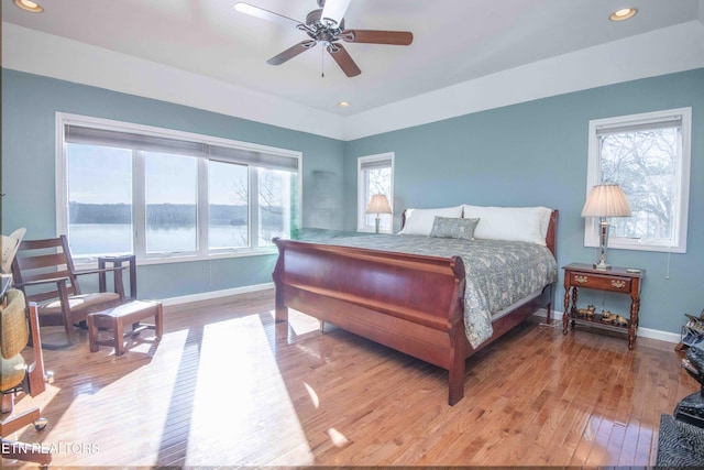 bedroom with recessed lighting, ceiling fan, baseboards, and wood finished floors