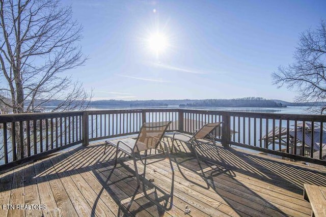 wooden deck featuring a water view