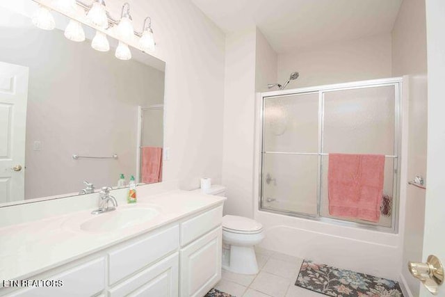 full bath with toilet, shower / bath combination with glass door, tile patterned flooring, and vanity