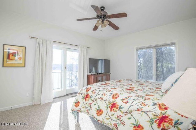 carpeted bedroom with access to exterior, ceiling fan, and baseboards