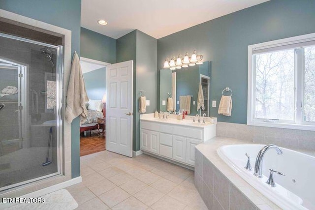 full bathroom featuring a stall shower, a wealth of natural light, and a tub with jets