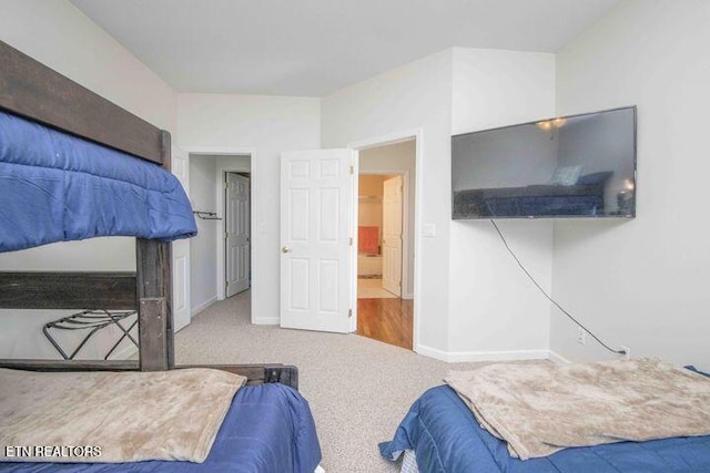 carpeted bedroom featuring baseboards