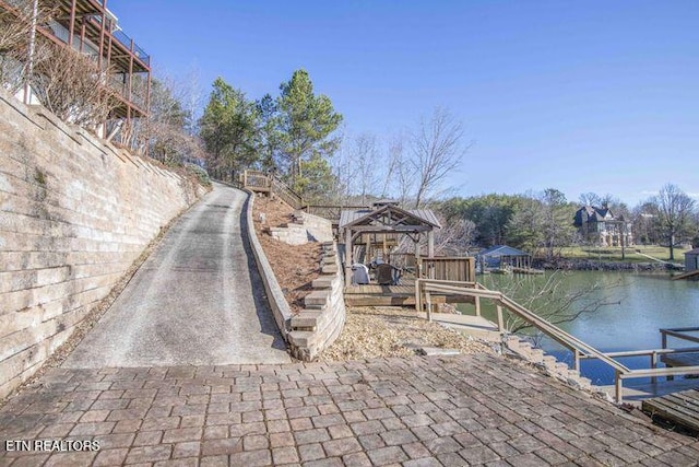 exterior space featuring a gazebo and a water view