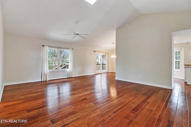 spare room featuring vaulted ceiling, ceiling fan, baseboards, and wood finished floors