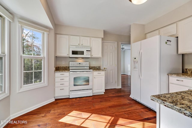 kitchen featuring white appliances, dark wood-type flooring, white cabinetry, and baseboards